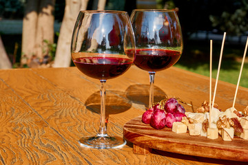 Glasses Of Fine Red Wine With Grape and cheese