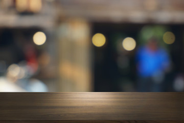 Empty dark wooden table in front of abstract blurred bokeh background of restaurant . can be used for display or montage your products.Mock up for space.