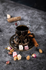 A glass of tea, pistachios, turkish lokum and cinnamon