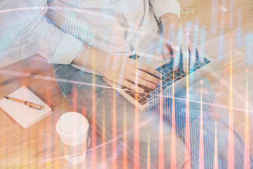 Forex graph with businessman working on computer in office on background. Concept of analysis....