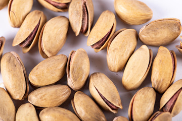 Obraz premium Pistachios on a white background. top view