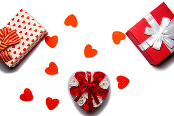 Red gift boxes and red hearts on a white background, isolated.