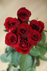 bouquet of red roses on a wooden background
