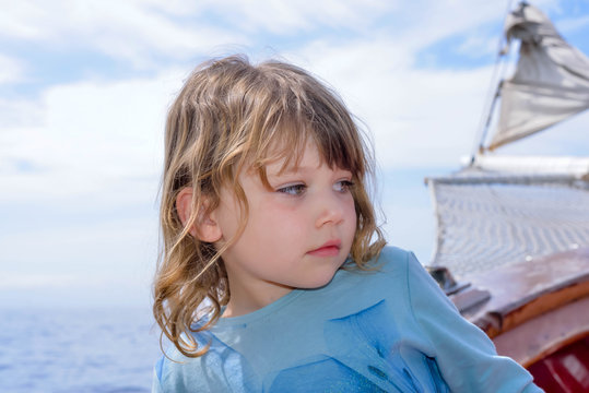 cute little girl on an expedition on an old sailboat