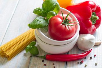 Composition with pasta cooking ingredients on wooden table in the kitchen still life art food
