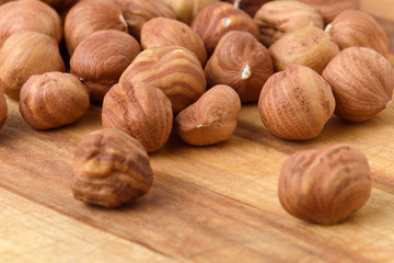 Ripe hazelnuts in bulk on a wooden table