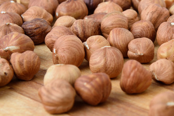 Ripe hazelnuts in bulk on a wooden table