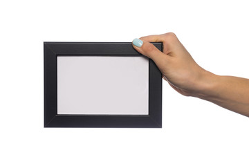 beautiful female hand holds a frame for a photo with an empty place for an inscription. isolated on a white background. mock up