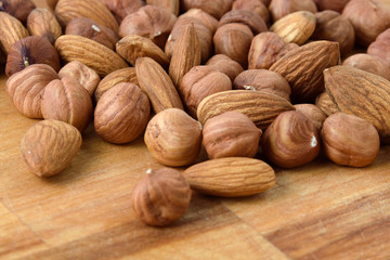A mixture of ripe hazelnuts on a wooden table
