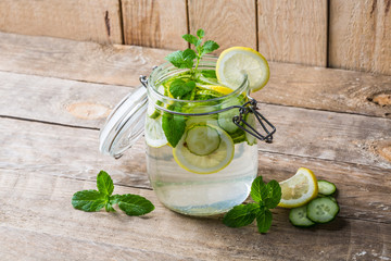 Lemon and cucumber detox water in glass jar