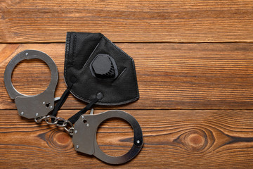 medical respirator and handcuffs on a table concept of prisoners need the respirators and masks