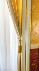 Curtain with warm sunlight close-up with decorative elements
