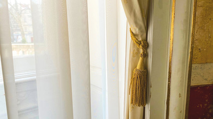 Curtain with warm sunlight close-up with decorative elements