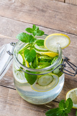 Lemon and cucumber detox water in glass jar