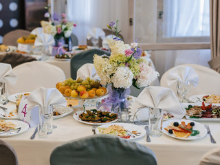 festive table in the restaurant with plates, glasses and Cutlery on a white tablecloth