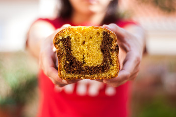 Young woman holding a piece of cake
