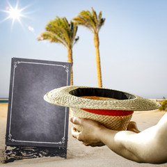 Woman hand with empty hat and blackboard of free space for your text.Copy space and summer blurred beach 