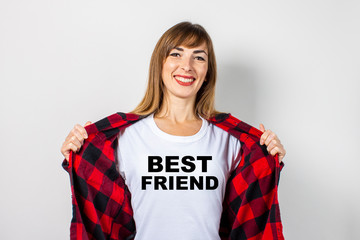 Young woman with a smile in a red shirt and white t-shirt on a white background. T-shirt Best...