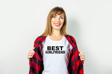 Young woman with a smile in a red shirt and white t-shirt on a white background. T-shirt text added...