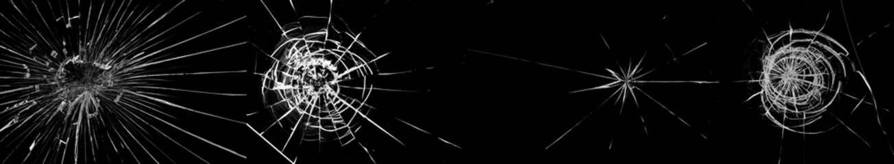 Round white cracks in glass on black background.