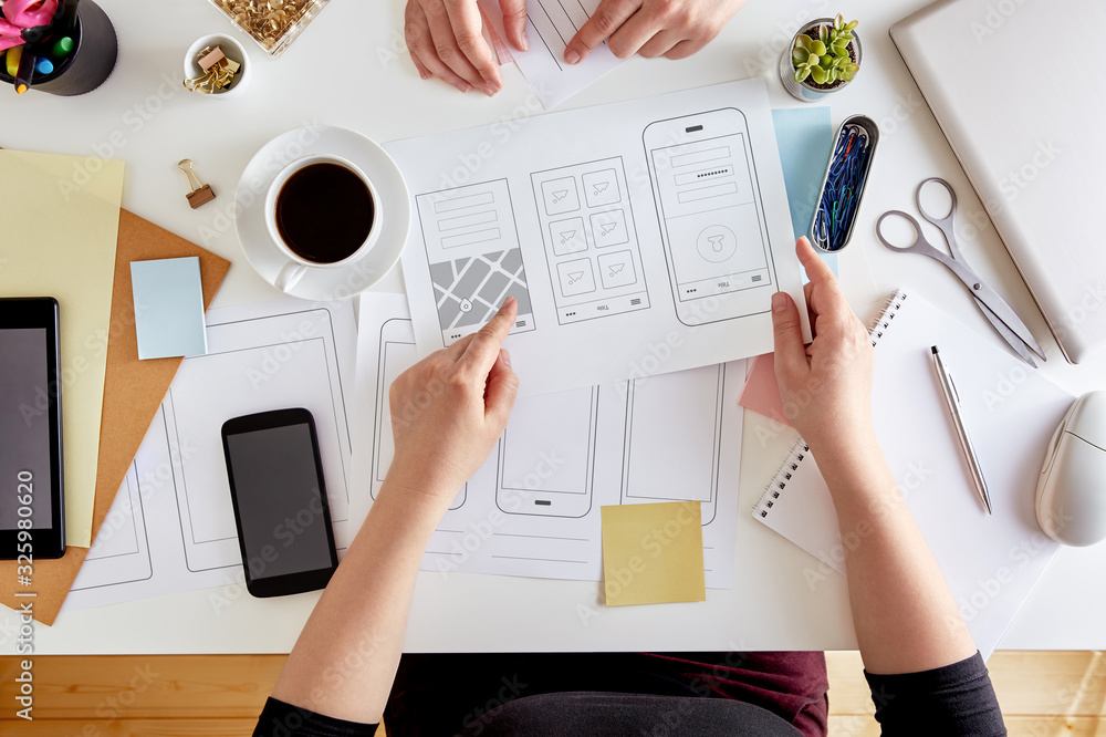 Sticker ux graphic designers planning out the structure of a mobile application. wireframing stage of a web 