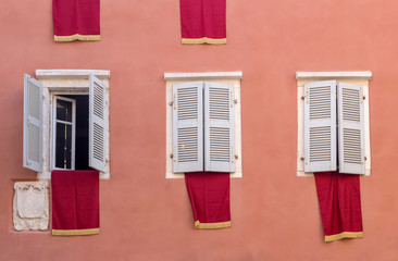 Fototapeta na wymiar The red flags on houses in Easter (Island Corfu, Greece)