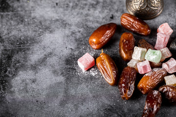 Turkish lokum with oriental dates on the right side of marble