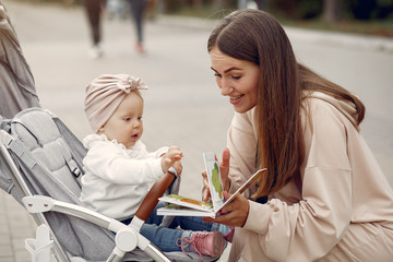 Mother with son. Woman use the carriages. Family in a autumn city
