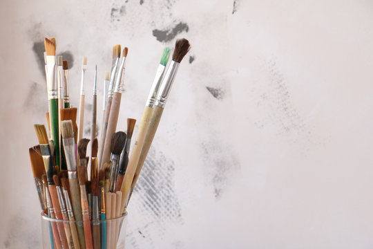 brushes for painting in a glass on a neutral background