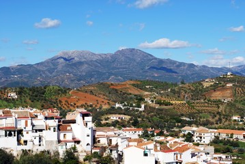 View over town rooftops towards the mountains, Guaro, Spain.