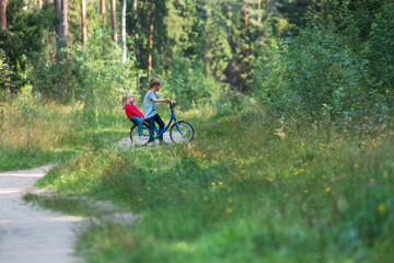 boy and girl on bike ride in nature, active lifestyle