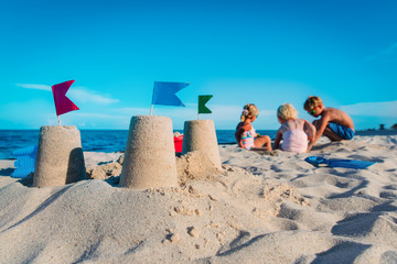 Fototapeta na wymiar sand castle and kids play with sand on beach