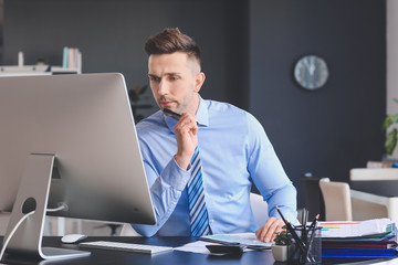 Male accountant working in office