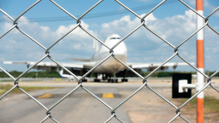 The metal fence prevented unauthorized persons from entering the airport area.