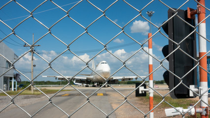 The metal fence prevented unauthorized persons from entering the airport area.