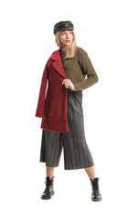 Young woman in warm sweater on white background