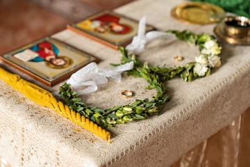 wedding in Church wreaths candles icons on table 