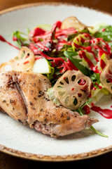 Close up of roasted turkey garnished with arugula salad with fresh green apple and cranberry sauce