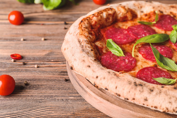Tasty pizza on wooden table, closeup