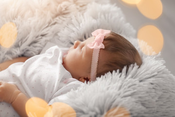 Cute little baby girl lying on plaid