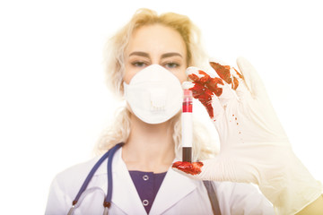 The doctor in bloodied gloves holds a test tube with blood. Toned