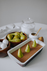 Cooking pear cake for Easter. Ingredients for making dough. Chocolate cake with pears in rustic style closeup.