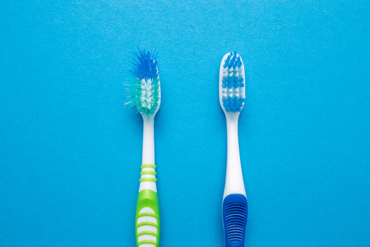 Used old and new toothbrush on a blue background.