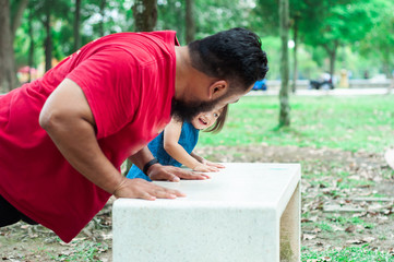 Bangi, Malaysia - February 17, 2019: Father workout with toddler at the park.
