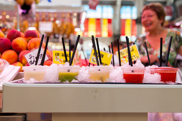 A glass of fruit smoothie in the ice in the market.