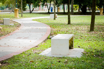 Fototapeta premium Green city park with benches in a tropical country,