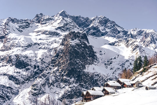 The traditional architecture of the Walser villages in the valleys of Monte Rosa, during a fantastic winter day, near the town of Alagna, Italy - February 2020.