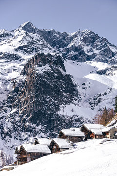 The traditional architecture of the Walser villages in the valleys of Monte Rosa, during a fantastic winter day, near the town of Alagna, Italy - February 2020.
