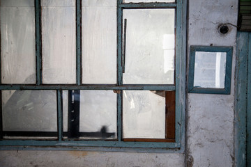 dirty windows of abandoned house