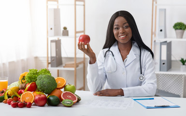 Beautiful doctor dietologist holding apple in her hand